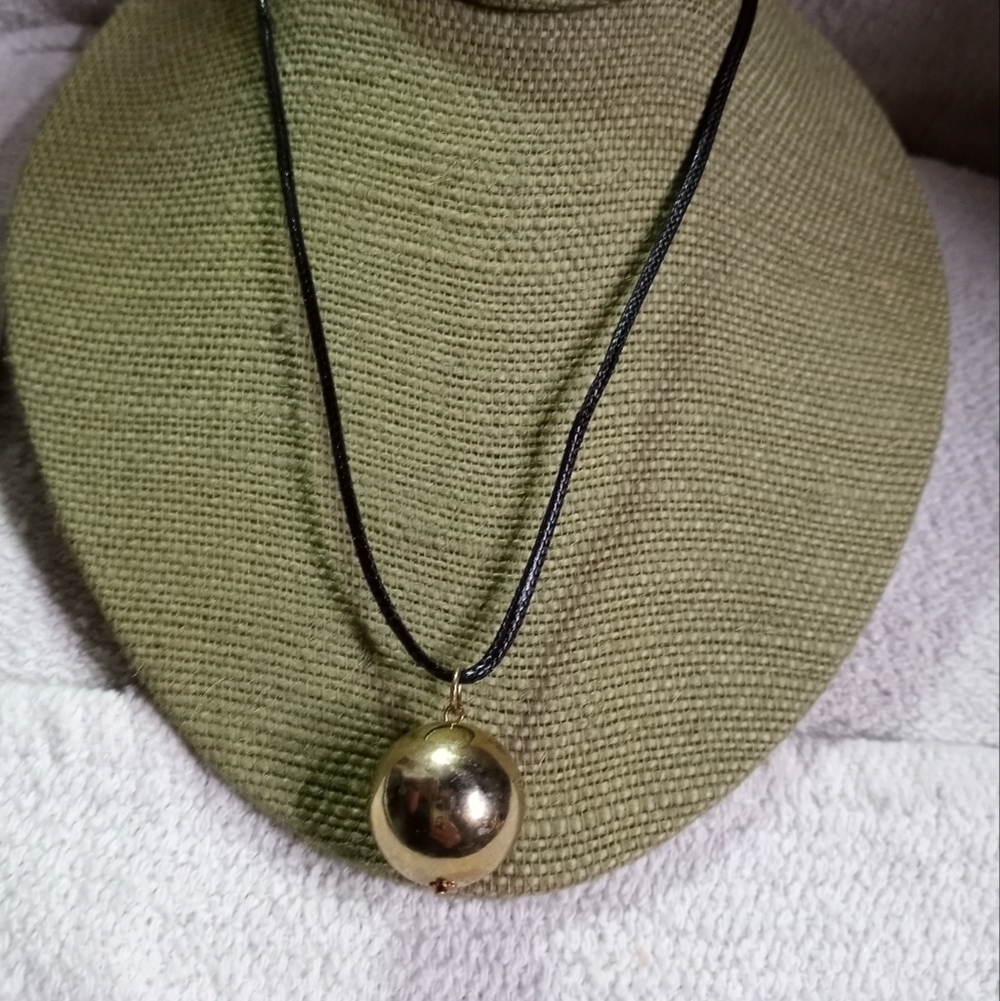 Goldtone Ball pendant on black cord necklace